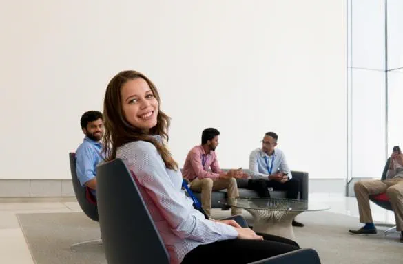 Intern sitting in chair smiling for photo