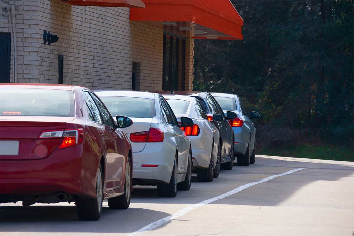 A long line of cars at a drive-through window