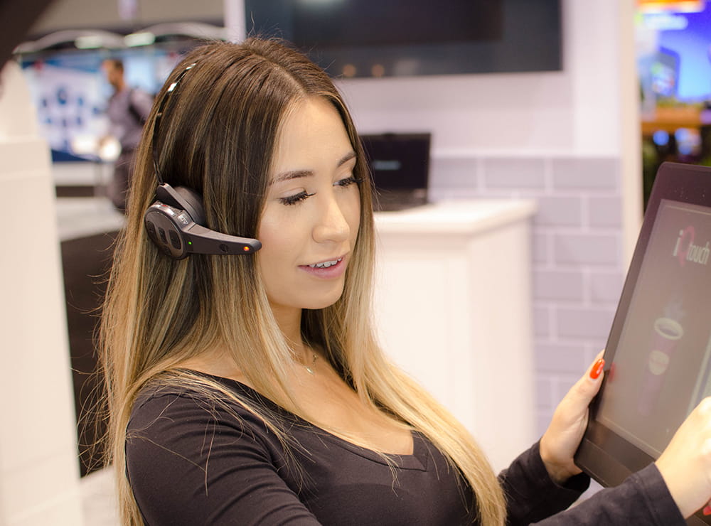 Drive-thru employee wearing an Attune II headset
